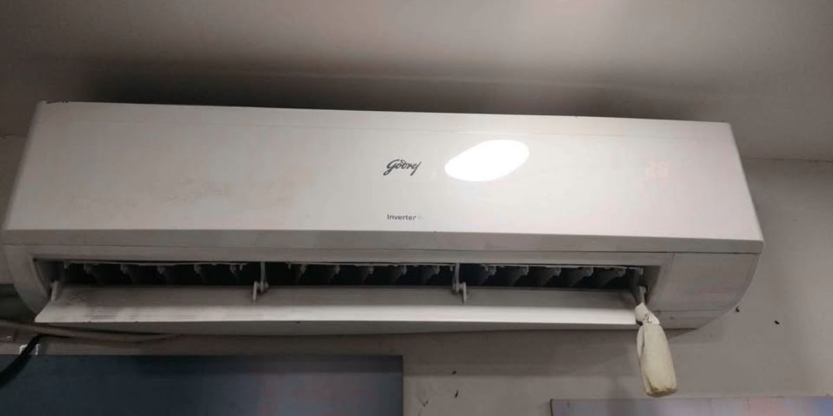 Godrej 2 Ton 5 Star inverter split AC (24LINV5R32-WWR) indoor unit with air outlet flap open, showing wide swing louver design